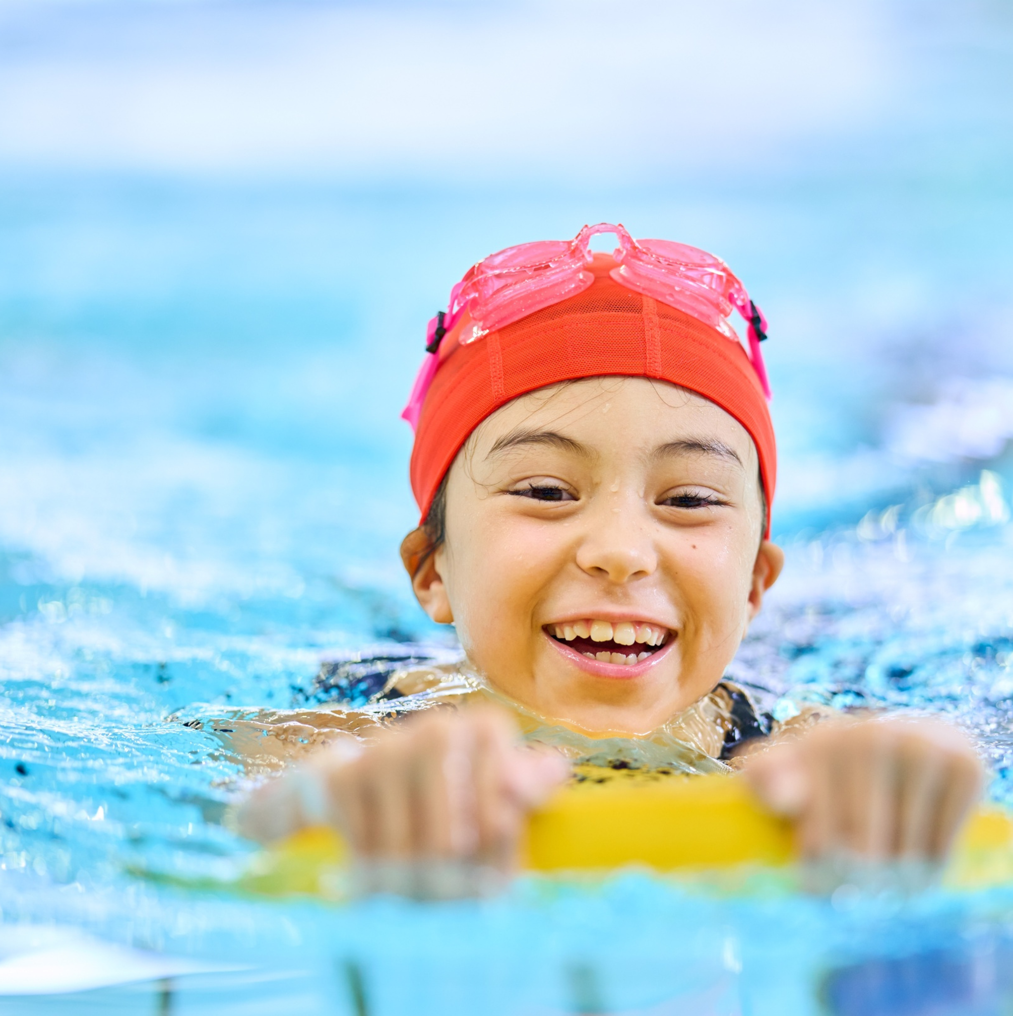 Child swimming in a pool with inflatable
