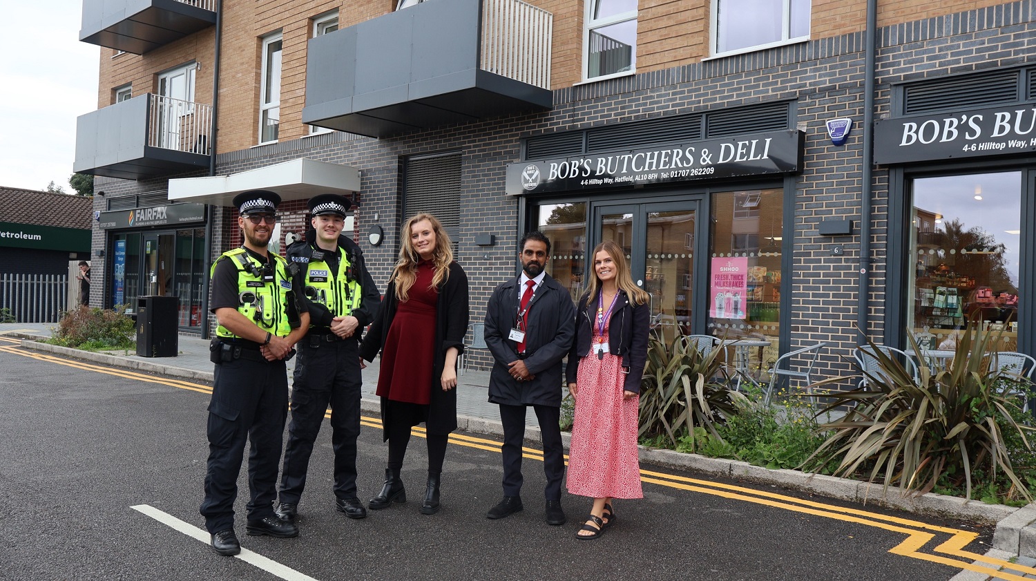 Cllr Sandreni with police officers and ASB officers outside shops in High View.